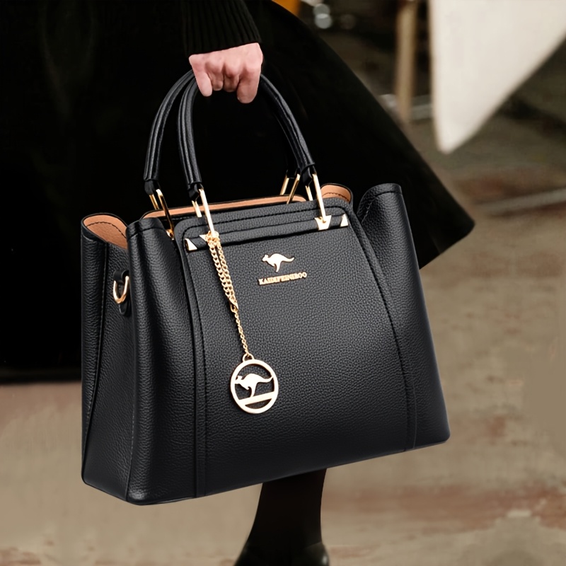 32db0290-0c7d-4b44-8f23-b02165215226.jpg Women's Stylish Black Handbag with Golden-Tone Hardware & Detachable Shoulder Strap - High Quality, Lightweight, and Elegant Design for Everyday Use, Designer Handbags - الصورة 1