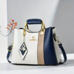 ⁦2024 New Women's Color-Block Tote Bag with Adjustable Crossbody/Shoulder Strap, Golden-Tone Hardware & Magnetic Closure - High Quality Casual Handbag for Commuting, Work, Travel - Navy/Beige/White Contrast Design, Crossbody Purse, Commuting Accessory, Dur⁩ - الصورة ⁦2⁩