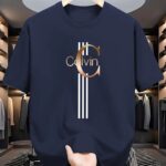 ⁦Men's Casual Calvin Print T-Shirt - Black with Golden Stripe Design, Comfortable Polyester Crew Neck Tee for Everyday Streetwear, Summer Essential⁩ - الصورة ⁦19⁩